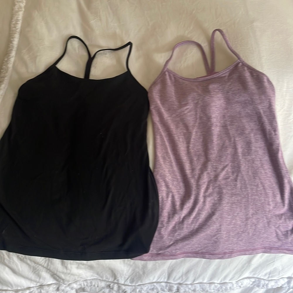 Two lulu lemon tank tops. Built in bra. Color black and light purple. Size 4